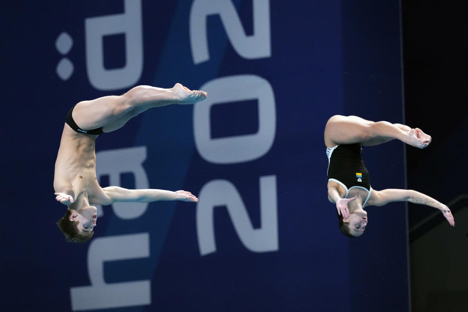 Kyrylo Azarov and Anna Pysmenska of Ukraine compete during the mixed 3m synchronised diving final at the World Aquatics Championships in Doha, Qatar, Saturday, Feb. 10, 2024. (AP Photo/Hassan Ammar)