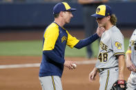 Milwaukee Brewers manager Craig Counsell, left, takes the ball from relief pitcher Trevor Gott (48) as Gott is removed during the sixth inning of the team's baseball game against the Miami Marlins, Saturday, May 14, 2022, in Miami. (AP Photo/Lynne Sladky)