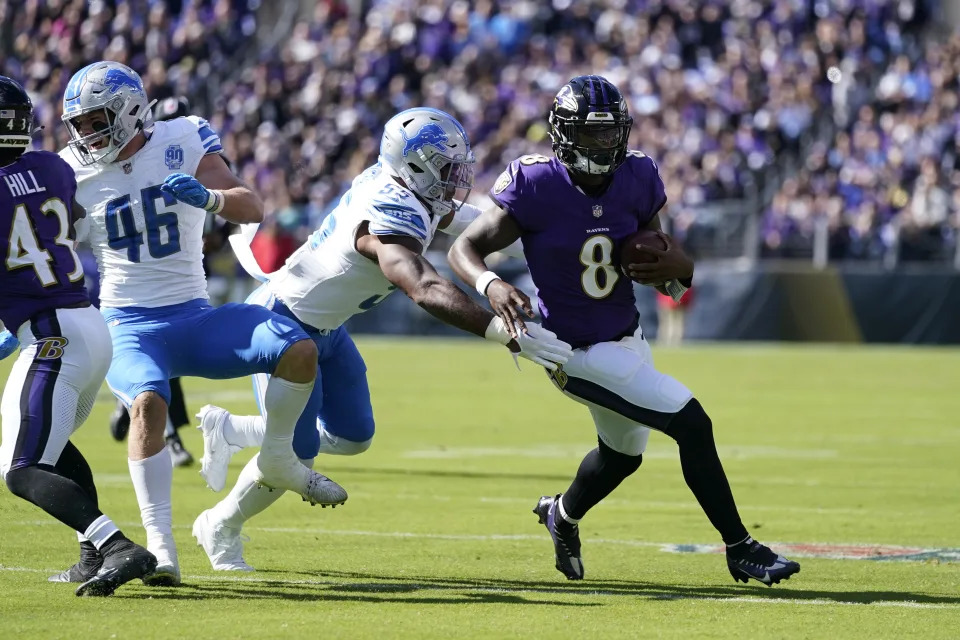 Baltimore Ravens quarterback Lamar Jackson (8) is chased by Detroit Lions linebacker Derrick Barnes (55) during the first half of an NFL football game, Sunday, Oct. 22, 2023, in Baltimore. (AP Photo/Alex Brandon)