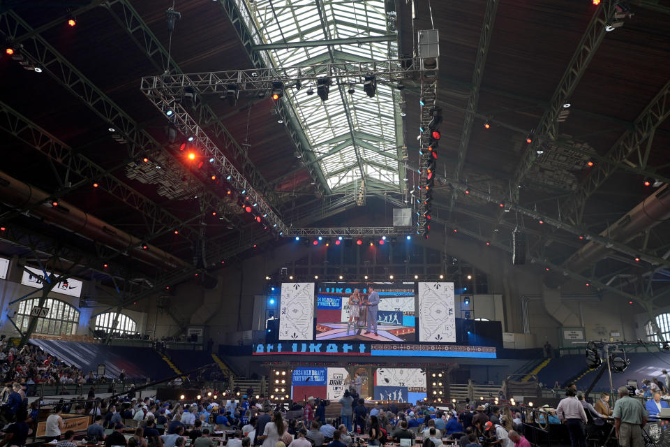 Attendees look on during the MLB baseball draft at the Cowtown Coliseum in Fort Worth, Texas, Sunday, July 14, 2024. (AP Photo/LM Otero)