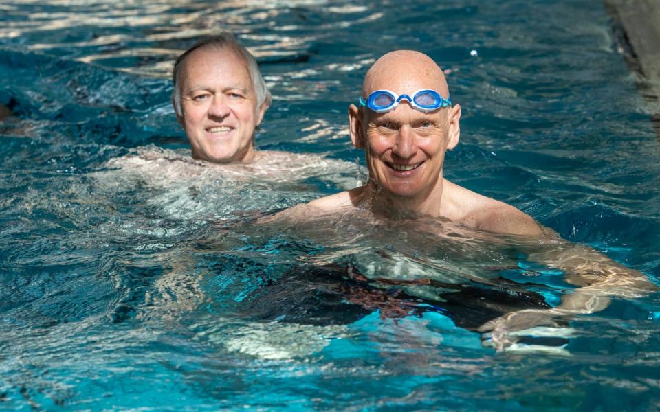 The Telegraph's Jim White swimming with, Olympian, Duncan Goodhew on the first day of reopening of indoor swimming facilities, at the Clissold Leisure Centre, Stoke Newington, London -  Geoff Pugh