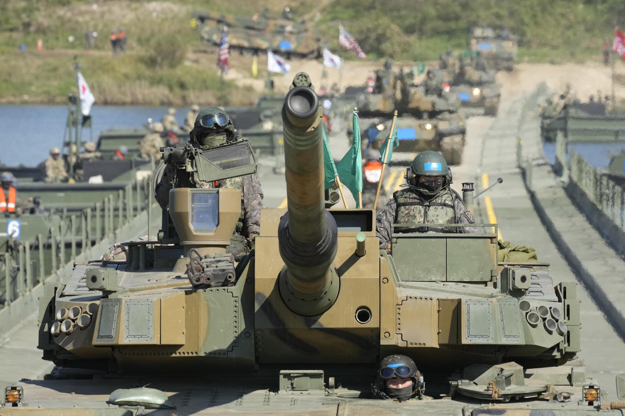 South Korean Army K2 tanks cross a floating bridge on the Namhan River during a joint river-crossing drill between South Korea and the United States in Yeoju, South Korea on Oct. 19, 2022. (Lee Jin-man/AP)