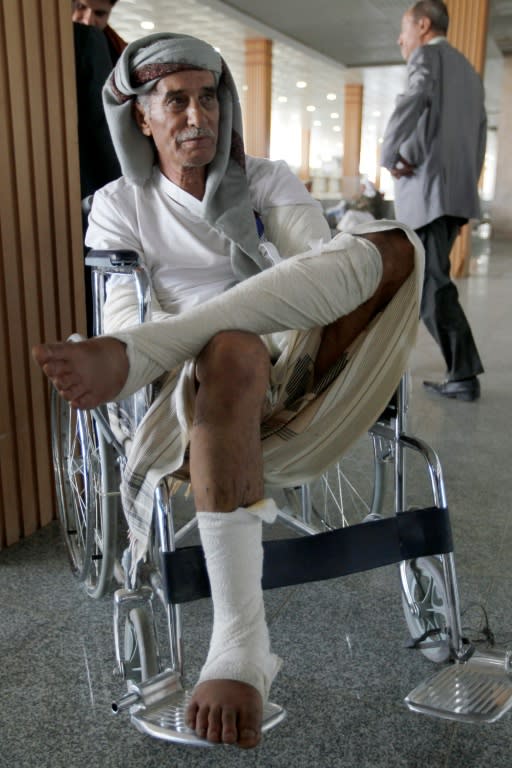 A wounded Yemeni man sits in the airport in Sanaa on October 15, 2016, as he waits for an Omani plane to evacuate him