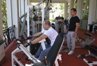 Russian President Vladimir Putin (L) and Prime Minister Dmitry Medvedev exercise in a gym at the Bocharov Ruchei state residence in Sochi, Russia, August 30, 2015. REUTERS/Yekaterina Shtukina/RIA Novosti/Pool