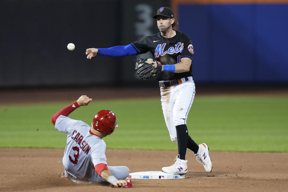 New York Mets' Jeff McNeil throws out St. Louis Cardinals' Paul DeJong at first base after forcing out Dylan Carlson on a double play during the seventh inning of a baseball game Friday, June 16, 2023, in New York. (AP Photo/Frank Franklin II)