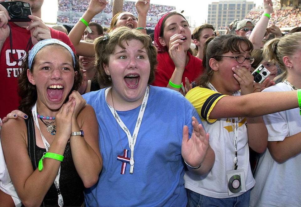 Allison Dirr (L) and Annie Schultz (C) react to DC Talk performing at a Billy Graham mission in Cincinnati, Ohio. (Credit: Mike Simons via Getty Images)