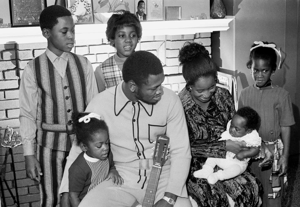 FILE - In this file photo taken Nov. 22, 1970, heavyweight champion Joe Frazier and his family pose for a family portrait after he returns from a successful defense of his boxing title in Philadelphia. While his wife Florence tries to make their youngest, Natasha, 12 weeks, Joe holds Jo-Netta. Standing behind them, from left, are Jaquelyn, 9, Marvis, 10, and Weatha, 7. The former champion died after a brief fight with liver cancer. He was 67. The family issued a release confirming the boxer's death on Monday, Nov. 7, 2011. (AP Photo, File)