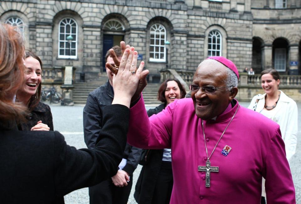 Desmond Tutu giving high-fives to students after receiving an honorary degree at Edinburgh University in 2009 (Andrew Milligan/PA) (PA Wire)