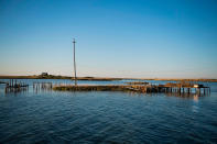 <p>Supports jet out of the water where crab shanties used to stand on a patch of land now surrounded by water in Tangier, Virginia, May 15, 2017, where climate change and rising sea levels threaten the inhabitants of the slowly sinking island.<br> (Jim Watson/AFP/Getty Images) </p>