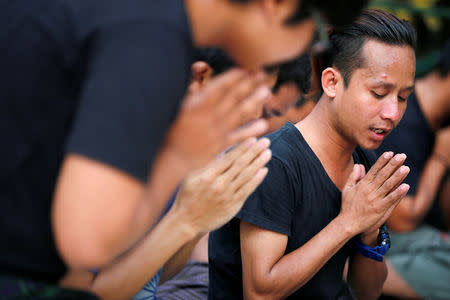 Friends of arrested Reuters journalists Wa Lone and Kyaw Soe Oo pray at Shwedagon Pagoda in Yangon, Myanmar, January 7, 2018. REUTERS/Stringer