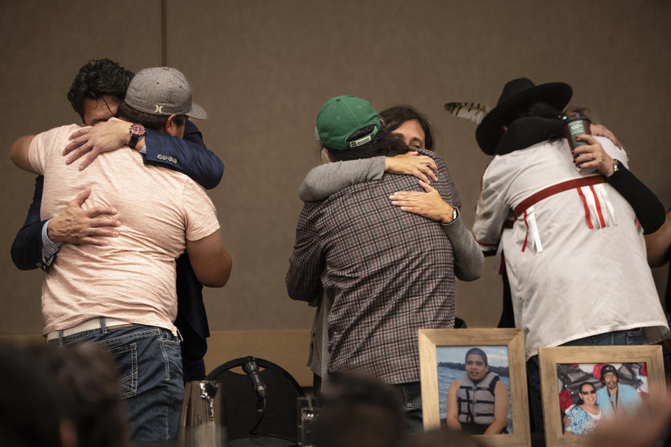 Family of the victims of a series of stabbings on the James Smith Cree Nation reserve in the Canadian province of Saskatchewan hug following a news conference in Saskatoon, Saskatchewan on Wednesday, Sept. 7, 2022. Myles Sanderson, 32, and his brother Damien, 30, are accused of killing 10 people and wounding 18 in a string of attacks across an Indigenous reserve and in the nearby town of Weldon. Damien was found dead Monday, and police were investigating whether his own brother killed him. (AP Photo/Robert Bumsted)