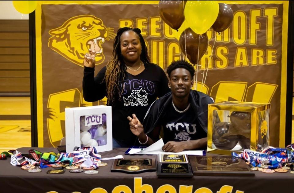 Jayden Douglas signs his national letter of intent to attend TCU as his mom, Christine, looks on.