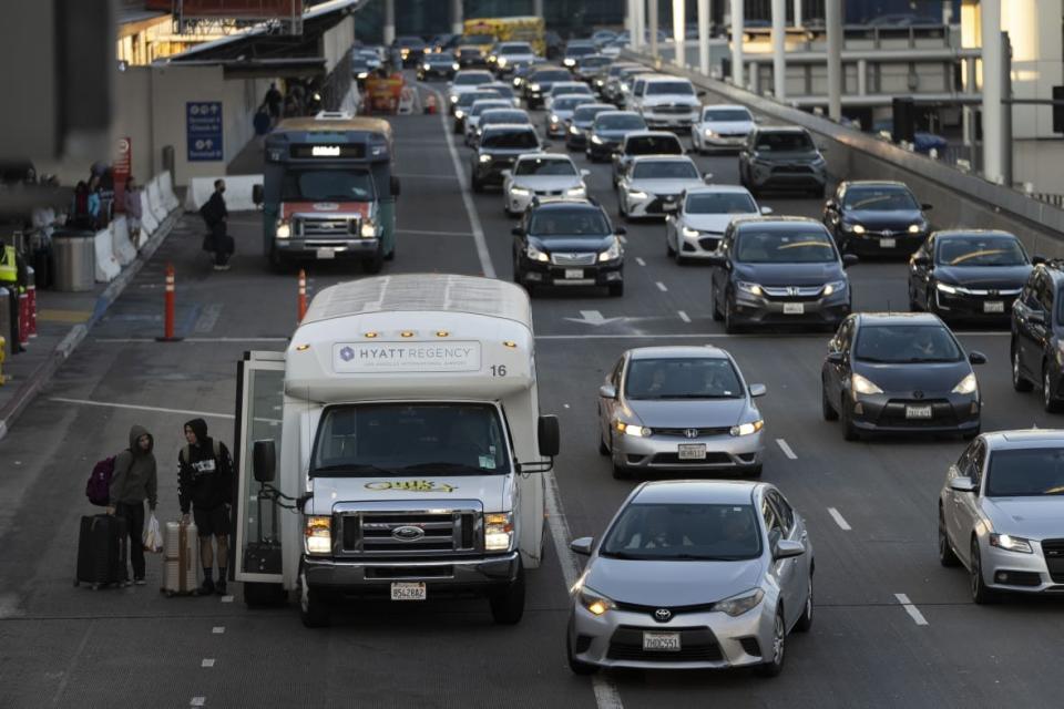 Travelers are dropped off on Dec. 19, 2022 at the Los Angeles International Airport in Los Angeles. (AP Photo/Jae C. Hong)