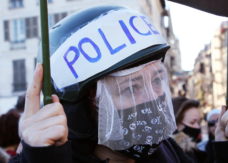 A protestor gestures, in Bayonne, southwestern France, Saturday, Nov. 21, 2020. Rights campaigners and journalists organizations staged street protests in Paris and other French cities against a security bill that they say would be a violation of the freedom of information. The proposed measure would create a new criminal offense of publishing images of police officers with intent to cause them harm. (AP Photo/Bob Edme)