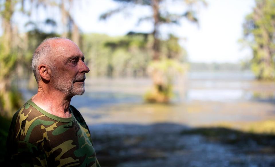 Terry Ryan, co-founder of the Tallahassee Sewage and Wakulla Basin advocacy group, stands in front of Lake Munson on Saturday, June 4, 2022. The lake is closed due to harmful algal blooms. 