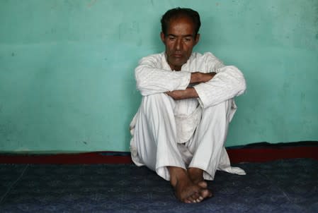 Mohammad Maqbool Malik, father of Uzair Maqbool Malik, sits inside his house in south Kashmir's Shopian