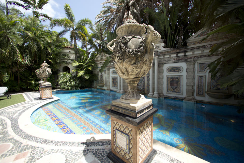 Decorative artwork stands in front of the 55 foot long swimming pool at the Versace mansion on Miami Beach, Fla., Tuesday, July 23, 2013. Though the Versace family hasn't owned the oceanfront mansion since 2000, auctioneers hope the Italian designer's legacy will attract bidders to the Miami Beach property when it goes up for auction Sept. 17. Gianni Versace was fatally shot on the mansion's stone front steps in 1997 by serial killer Andrew Cunanan. (AP Photo/J Pat Carter)