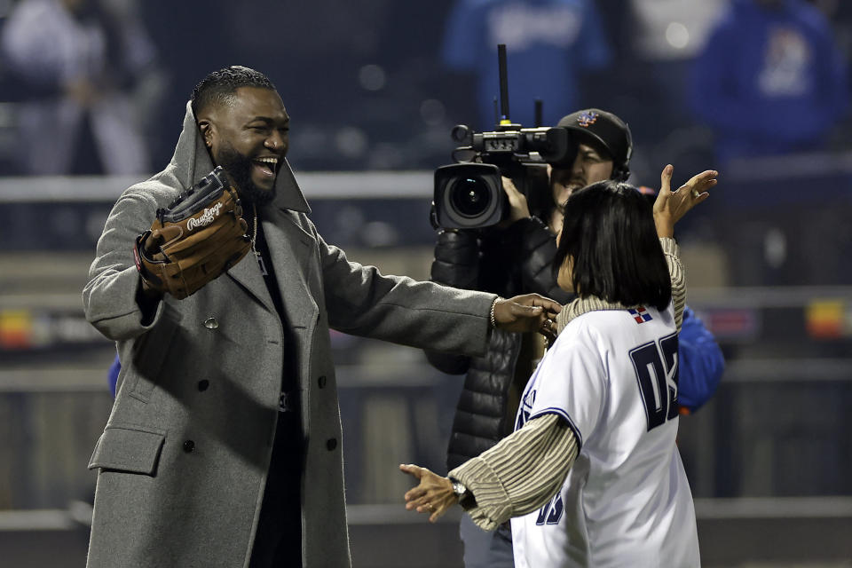 Former Boston Red Sox player David Ortiz,left, reacts after catching a ceremonial first pitch before the Tigres del Licey played the Águilas Cibaeñas in a Dominican Winter League baseball game at Citi Field, Friday, Nov. 10, 2023, in New York. (AP Photo/Adam Hunger)