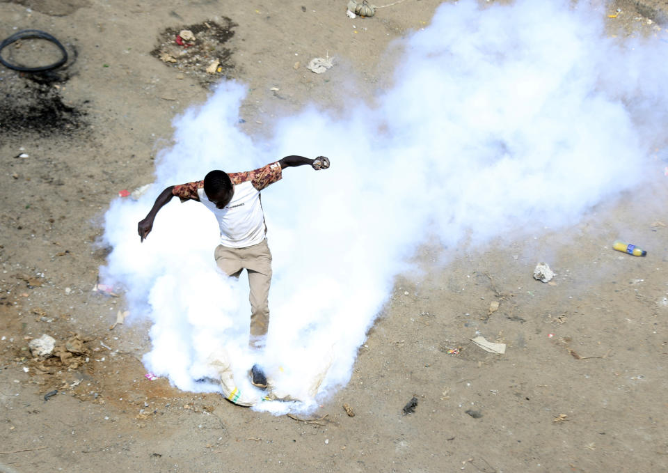 A protester caught in tear-gas during a mass rally called by the opposition leader Raila Odinga over the high cost of living in Kibera Slums, Nairobi, Monday, March 27, 2023. Police in Kenya are on high alert ahead of the second round of anti-government protests organized by the opposition that has been termed as illegal by the government. Police chief Japheth Koome insists that Monday's protests are illegal but the opposition leader Raila Odinga says Kenyans have a right to demonstrate.(AP Photo/Brian Inganga)