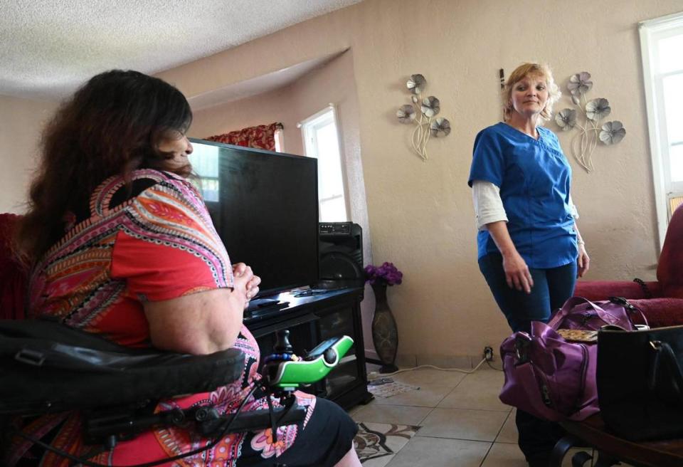 In-Home Support Services (IHSS) care worker Wendy Davenport, right, looks toward her client Jovonna Martinez Wednesday, March 15, 2023 in Fresno. Davenport and other SEIU workers are looking for a salary increase from $16.10/hour to $20/hour for the work they do.