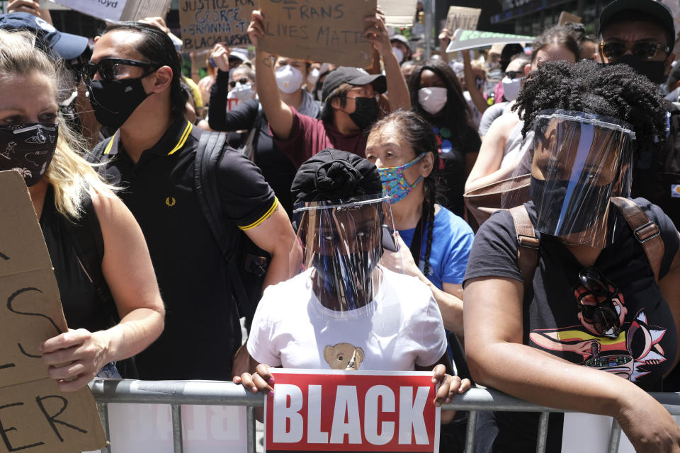 Protesters rally near the edge of Times Square in New York, Sunday, June 7, 2020. New York City lifted the curfew spurred by protests against police brutality ahead of schedule Sunday after a peaceful night, free of the clashes or ransacking of stores that rocked the city days earlier. (AP Photo/Seth Wenig)