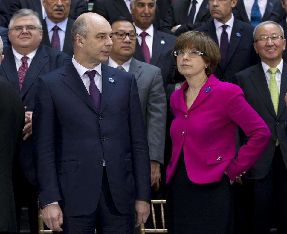 Russian Finance Minister Anton Siluanov, and Russian Monetary policy chief Ksenia Yudaeva speak during the G-20 finance ministers and central bank governors group photo on the sidelines of their meeting at World Bank Group-International Monetary Fund Spring Meetings in Washington, Friday, April 11, 2014. ( AP Photo/Jose Luis Magana)