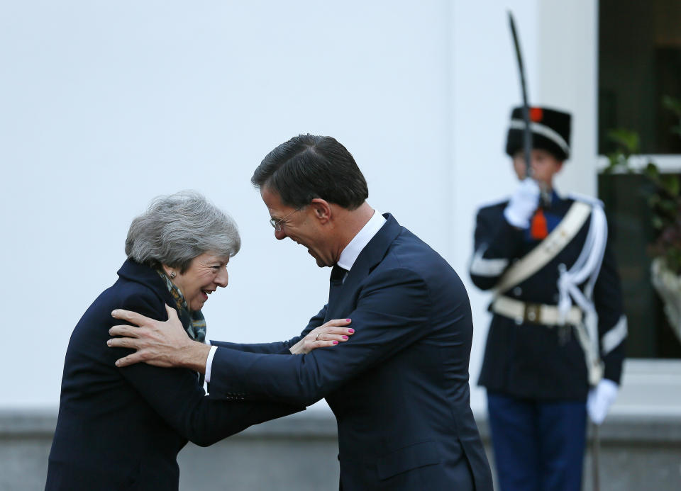 British Prime Minister Theresa May is greeted by Dutch Prime Minister Mark Rutte upon her arrival in The Hague, Netherlands, Tuesday, Dec. 11, 2018. Facing almost certain defeat, Prime Minister May on Monday postponed a vote in Parliament on her Brexit deal, saying she would go back to European Union leaders to seek changes to the divorce agreement. (AP Photo/Peter Dejong)