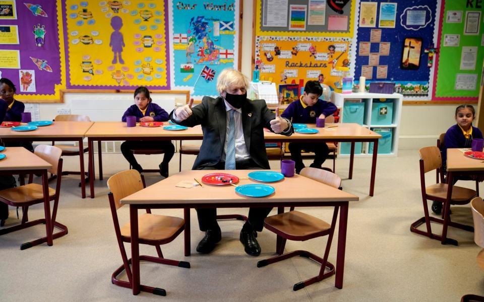 Boris Johnson gives a thumbs up as he joins a Year 2 maths lesson  - Getty