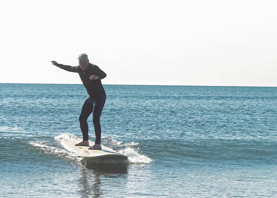 Tom Richardson, host of "Explore New England," learning to surf at North Beach in an episode of his show that will feature recreation at Hampton Beach.