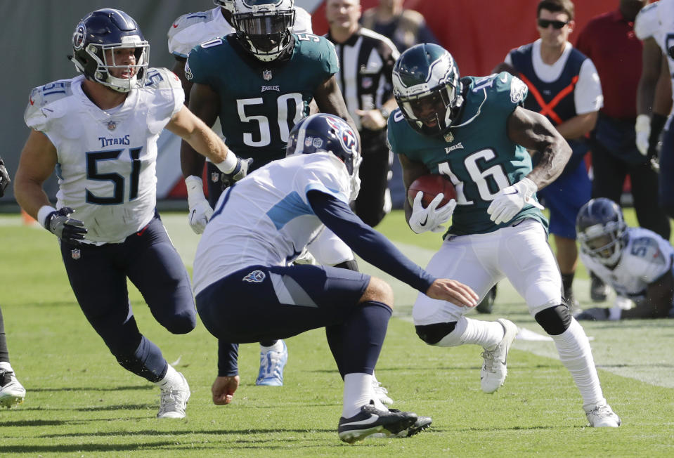 Tennessee Titans punter Brett Kern, center, makes a tackle on Philadelphia Eagles kick returner DeAndre Carter (16) in the second half of an NFL football game Sunday, Sept. 30, 2018, in Nashville, Tenn. (AP Photo/James Kenney)