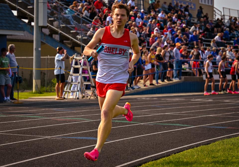 Shelby's Luke Dininger runs his leg of the 4x800 relay race as the Whippets set a new district meet record in the event.
