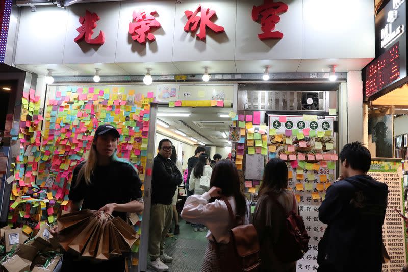 Protesters queue for a free Christmas dinner offered by a local restaurant in Hong Kong