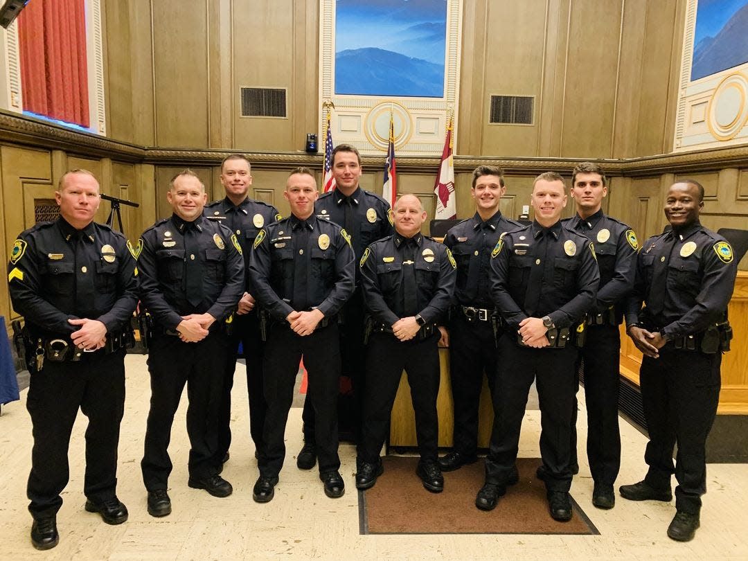 Asheville Police Chief David Zack poses with eight new department recruits.