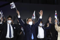 South Korean President Moon Jae-in, center, gives three cheers during the celebration of 75th anniversary of the Liberation Day at Dongdaemun Design Plaza in Seoul Saturday, Aug. 15, 2020. (Chung Sung-jun/Pool Photo via AP)