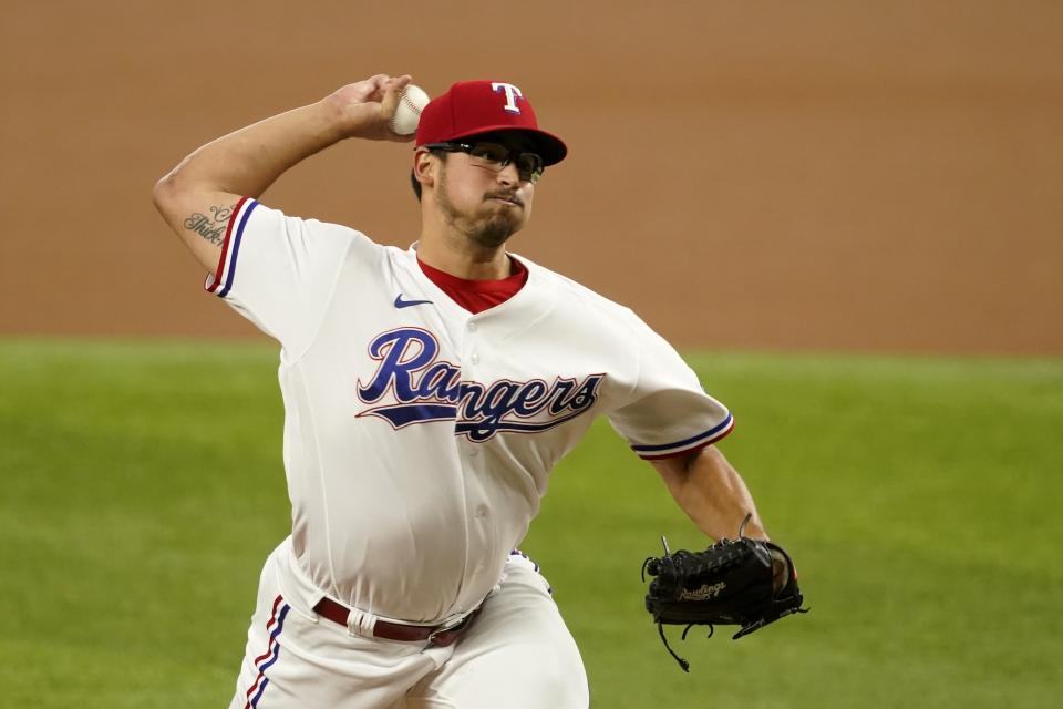 Texas Rangers starting pitcher Dane Dunning throws to a Los Angeles Angels batter during the first inning of a baseball game in Arlington, Texas, Monday, Aug. 2, 2021. (AP Photo/Tony Gutierrez)