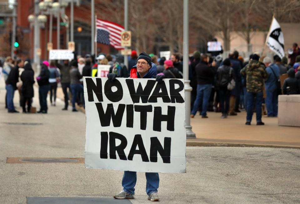 Air Force veteran Mike Fitzgerald, center, from Kirkwood, Mo., stands near a protest outside the Federal Courthouse in St. Louis on Saturday, Jan. 4, 2020. A top Iranian general and Iraqi militiamen were killed in a U.S. airstrike that sharply escalated tensions across the region. (David Carson/St. Louis Post-Dispatch via AP)