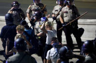 <p>A protester raises her hands after being contained by law enforcement, while being arrested during a march on Interstate 94 after a jury found St. Anthony Police Department officer Jeronimo Yanez not guilty of second-degree manslaughter in the death of Philando Castile, at the Minnesota State Capitol in St. Paul, Minnesota, U.S., June 16, 2017. Picture taken June 16, 2017. (Adam Bettcher/Reuters) </p>