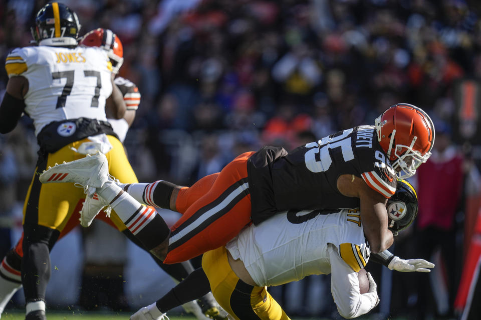 Cleveland Browns defensive end Myles Garrett (95) sacks Pittsburgh Steelers quarterback Kenny Pickett (8) during the first half of an NFL football game, Sunday, Nov. 19, 2023, in Cleveland. (AP Photo/Sue Ogrocki)