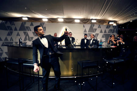 91st Academy Awards - Oscars Governors Ball - Hollywood, Los Angeles, California, U.S., February 24, 2019. Rami Malek winner of the Best Actor award for "Bohemian Rhapsody" opens a bottle of champagne. REUTERS/Mario Anzuoni