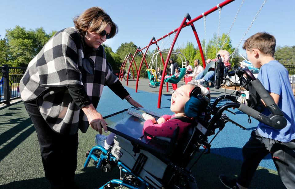 The All-Inclusive Playground at Sokol Park opened and was christened Mason's Place Wednesday, April 21, 2021, in Tuscaloosa. Terry Saban takes a moment to speak Lanie Hughey near the swing set. [Staff Photo/Gary Cosby Jr.]