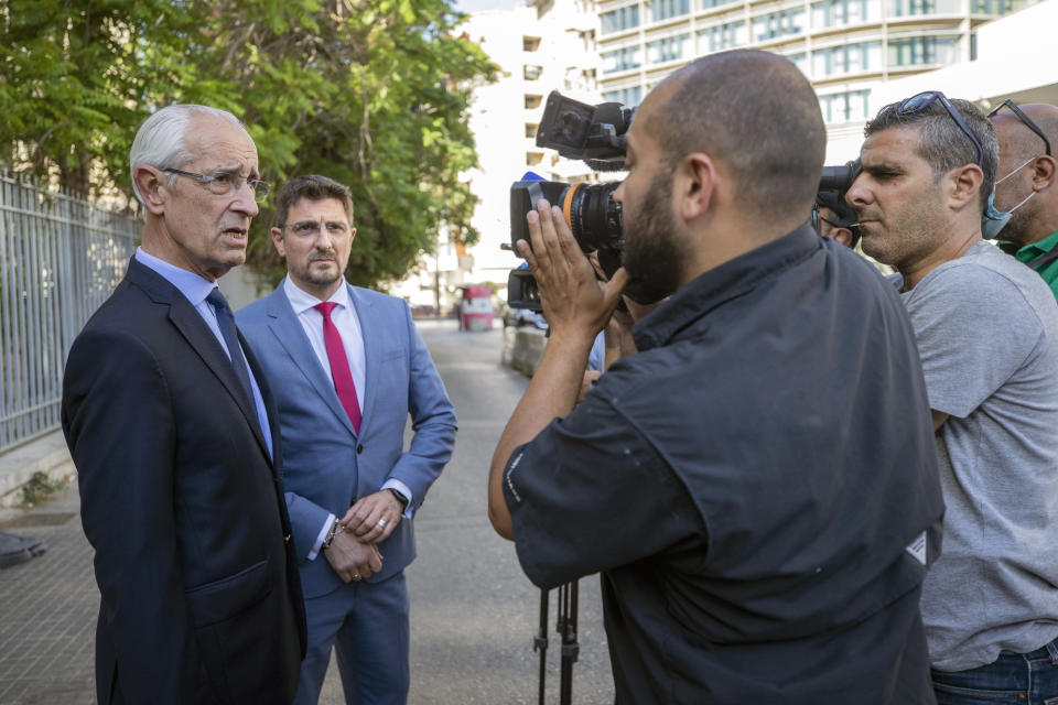 Members of Carlos Ghosn's defense team, lawyer Jean Yves Le Borgne, left, and Jean Tamalet, second from left, speak with journalists outside the Justice Palace in Beirut, Lebanon, Monday, May 31, 2021. A team of French investigators began questioning ex-Nissan boss Carlos Ghosn in Beirut on Monday over suspicions of financial misconduct, Lebanese judicial officials said. (AP Photo/Hassan Ammar)