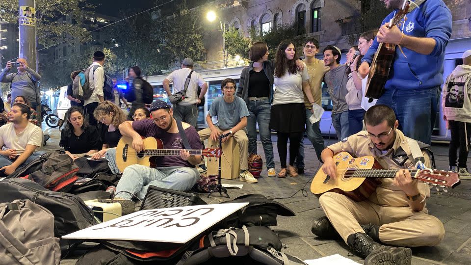 Yonatan Rapaport, center, plays guitar at a gathering of young Israelis in Jerusalem on Thursday, November 2. - Ivana Kottasova/CNN