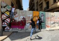 A demonstrator throws a stone during a protest against the government performance and worsening economic conditions, in Beirut