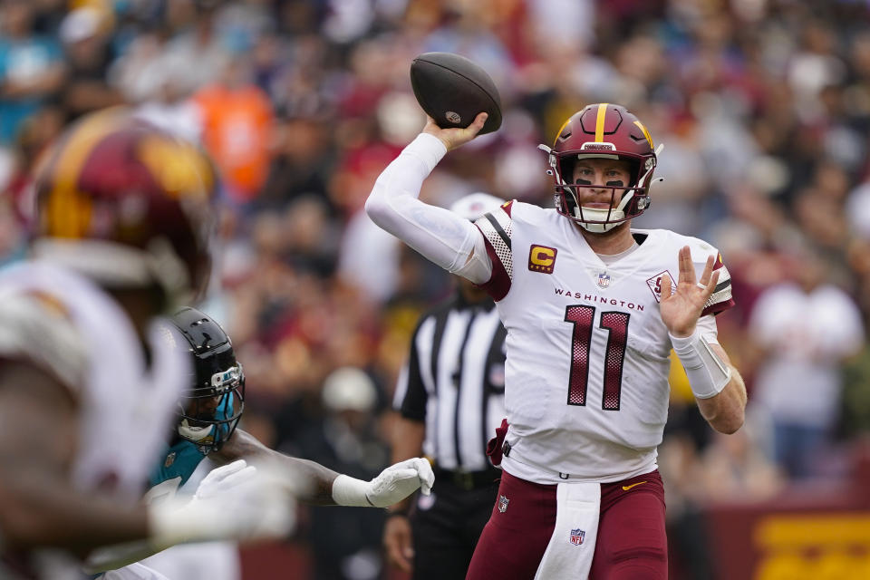 Washington Commanders quarterback Carson Wentz (11) throwing the ball downfield during the first half of an NFL football game against the Jacksonville Jaguars, Sunday, Sept. 11, 2022, in Landover, Md. (AP Photo/Patrick Semansky)