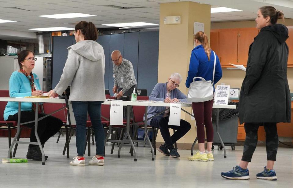 48th Precinct Chief Judge Jane Pasquini, left, election official Rick Gaskins, center and judge Susan Byrd, right, work with voters prior to their voting at Providence United Methodist Church on Tuesday, March 3, 2020.