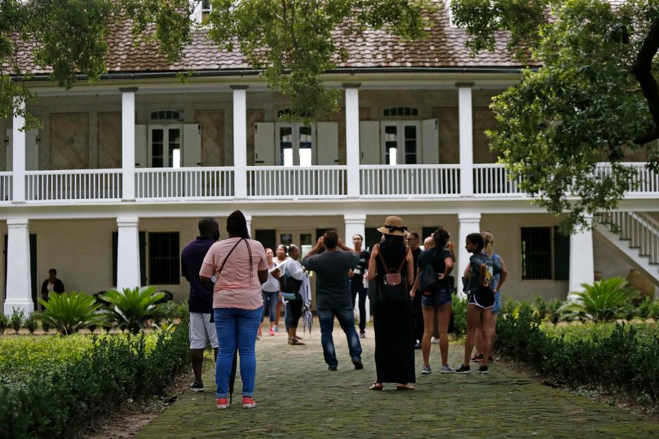 Visitors stand outside the main plantation house at the Whitney Plantation in Edgard, Louisiana. According to its website, it is the
only former plantation site in the state that is exclusively focused on slavery.