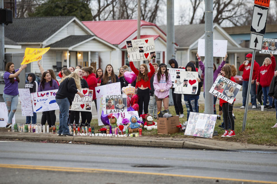 FILE - People gather at the intersection of 5th Avenue and 31st Street (U.S. 60) in Huntington, W.Va., Jan. 1, 2023, for a candlelight vigil after a 13-year-old girl was struck and killed there days earlier by a vehicle driven by an off-duty Cabell County sheriff's deputy. On Monday, Sept. 25, the family of the 13-year-old who was struck and killed filed a civil suit in federal court against the now-resigned officer and other county officials. Opal Slone, the mother of Jacqueline “Laney” Hudson, is requesting a jury trial against former Cabell County Sheriff’s Deputy Jeffrey Racer, accusing him of speeding when he fatally struck her daughter in December 2022 with his marked cruiser, among other allegations. (Ryan Fischer/The Herald-Dispatch via AP, File)