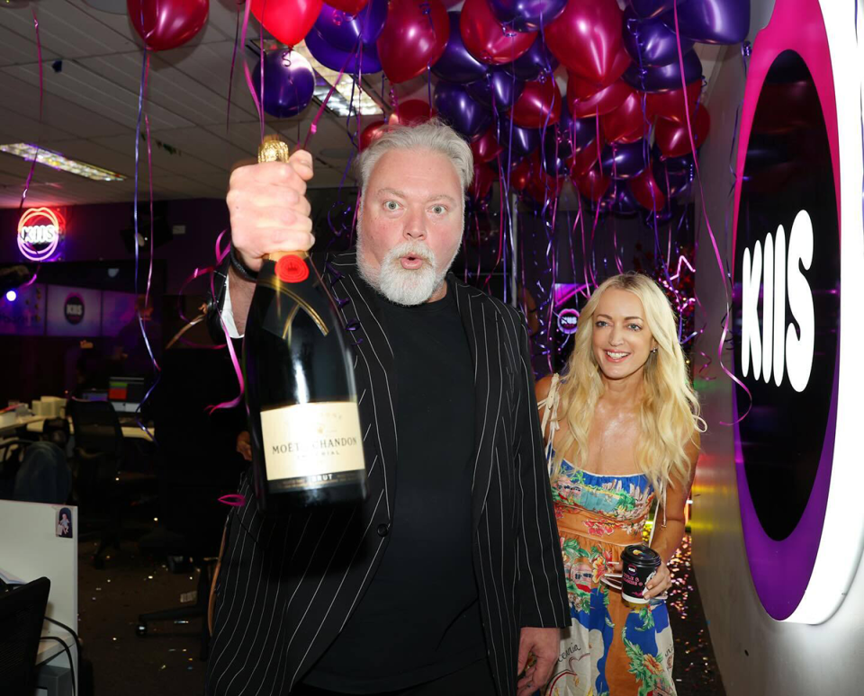 Kyle Sandilands and Jackie ‘O’ Henderson celebrating with champagne.