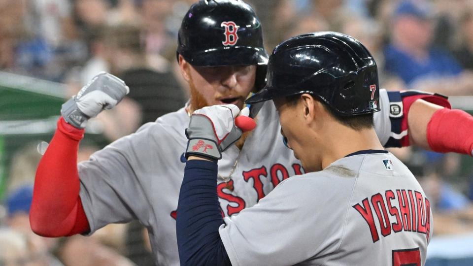 Boston Red Sox left fielder Masataka Yoshida (7) is greeted by designated hitter Justin Turner (2) after hitting a solo home run against the Toronto Blue Jays in the sixth inning at Rogers Centre