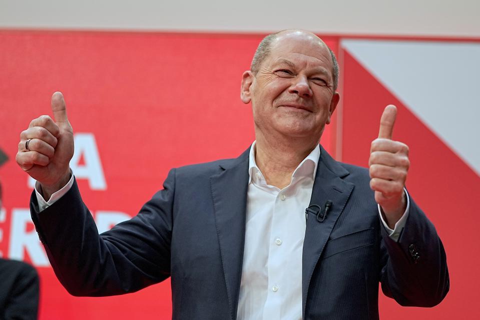 Olaf Scholz, SPD chancellor-designate and executive federal minister of finance, raises his thumbs after the SPD party convention at Willy Brandt House approved the planned coalition agreement in Berlin, Germany, Saturday, Dec.4, 2021. Delegates voted on a coalition agreement with the FDP and Bündnis90/Die Grünen to form a new federal government. (Michael Kappeler/dpa via AP)